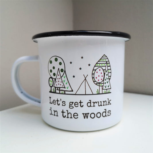 A white steel enamel mug with a black rim, with a handdrawn picture of a forest with a tent in the middle under stars, and written underneath in black type font - let's get drunk in the woods.