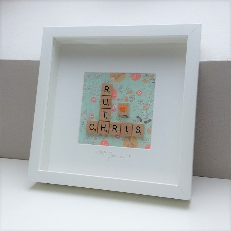 Personalised Wedding Engagement Scrabble name Frame with 2 names and orange heart on a green foliage background
