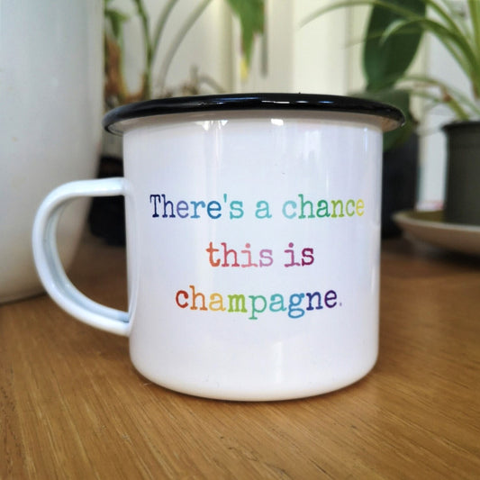 A White enamel mug with a black rim with the following on the front in rainbow lettering - there's a chance this is champagne