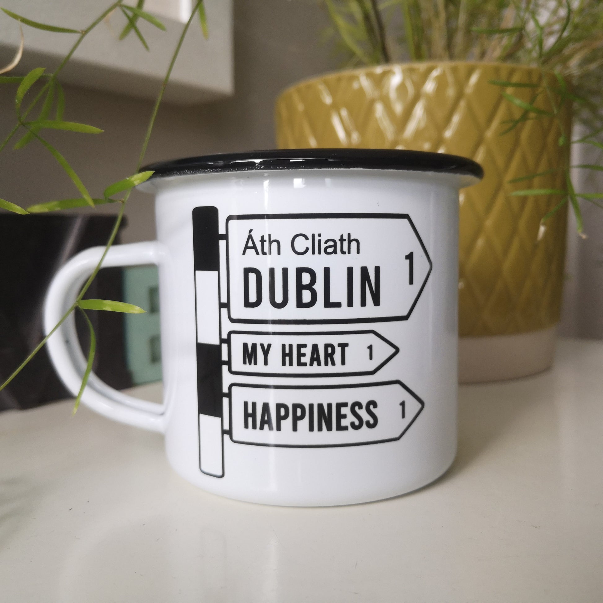 A Customised white steel enamel mug with your selected placename on it in an old fashioned black and white irish roadsign. This one points to Dublin! Along with My heart and Happiness.