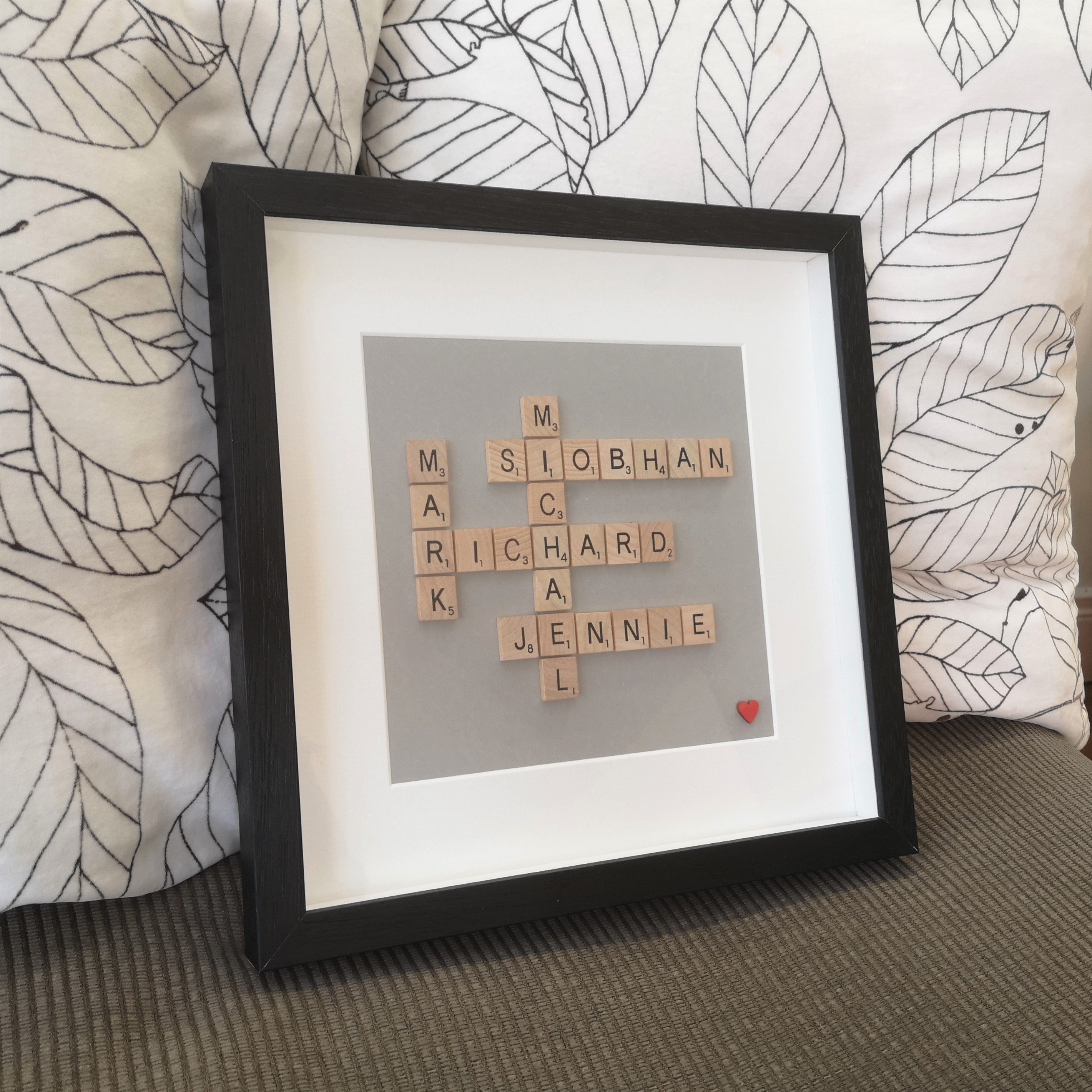 Family Names in wooden scrabble tiles on grey background in a handmade black 30x30cm deep box wooden frame