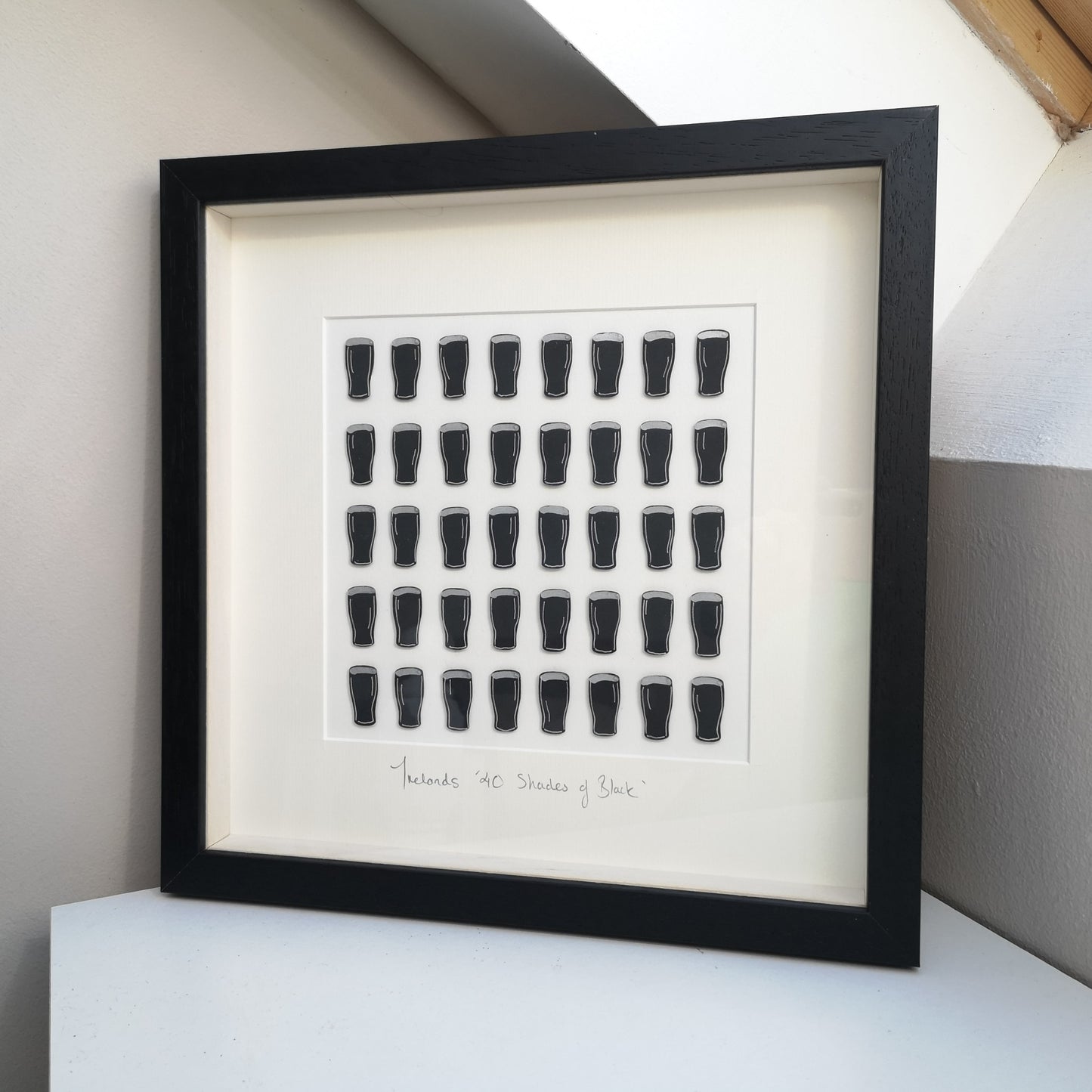 40 Shades of Black papercutting frame featuring 40 handcut and hand painted pints of guinness
