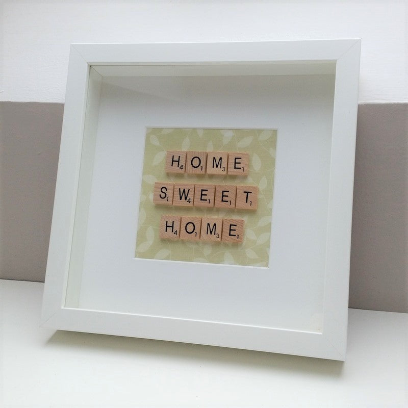 HOME SWEET HOME Scrabble tile White wooden Frame on a green leafy background