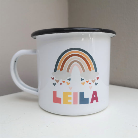 A white enamel mug with a cute colourful rainbow on it with hearts just below the clouds, and below the space to add your favourite little one's name.