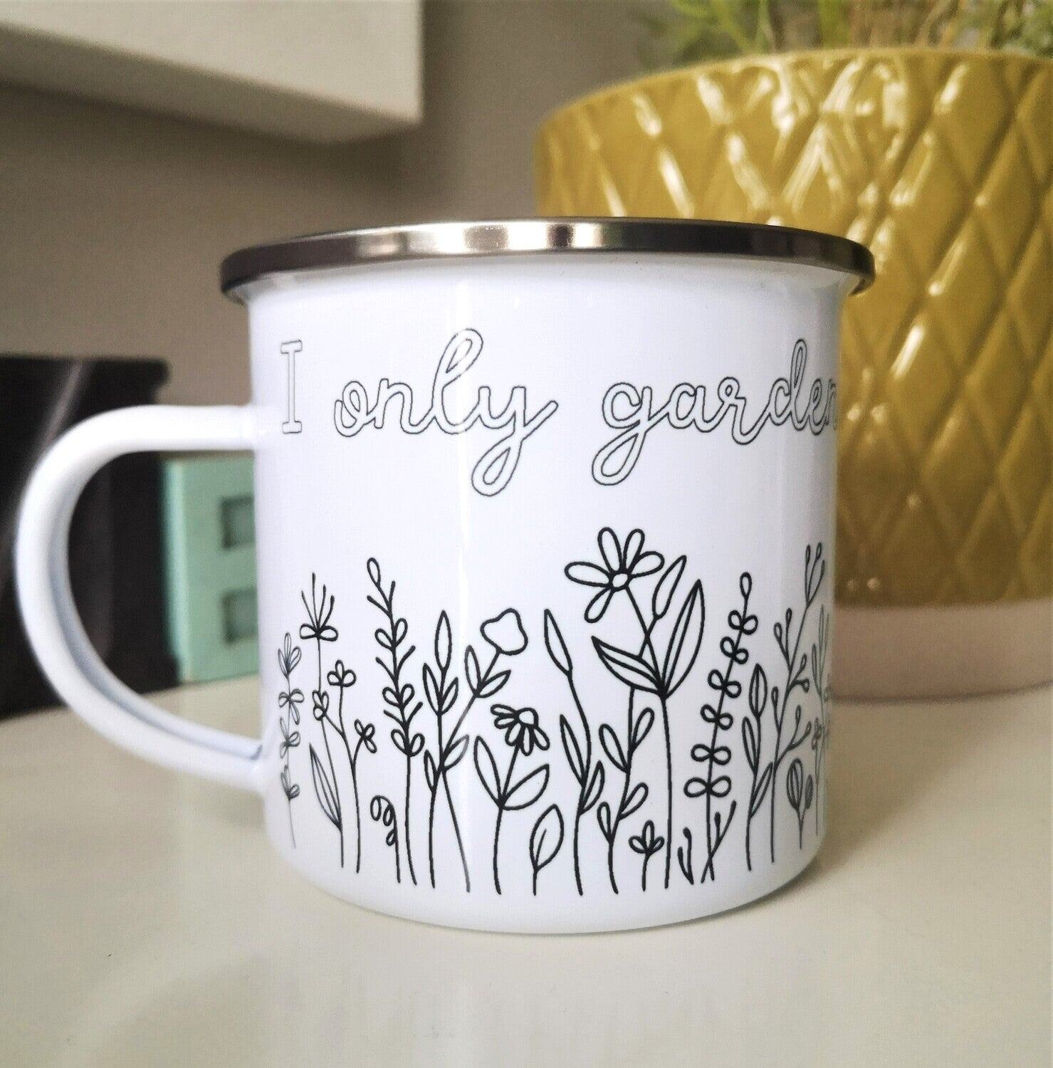 I only Garden to escape My Family enamel mug with black rim, flower border below the text, front view