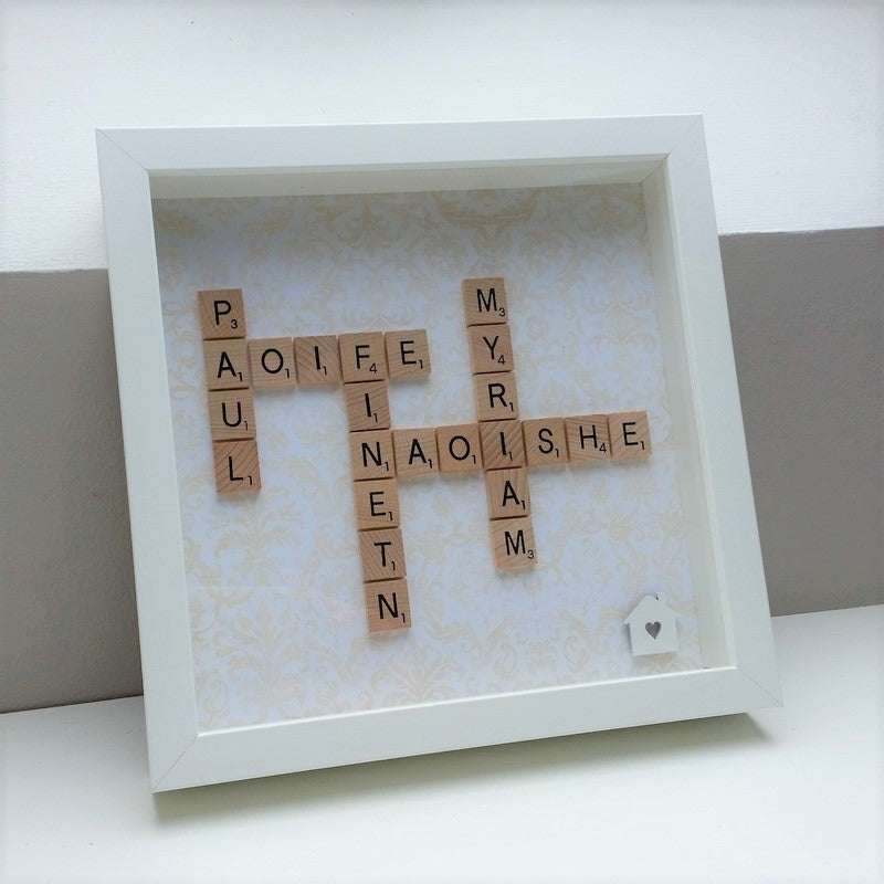 Personalised Family Scrabble name Frame with 5 names in wooden tiles and white wooden house embellishment on a soft cream and gold damask background
