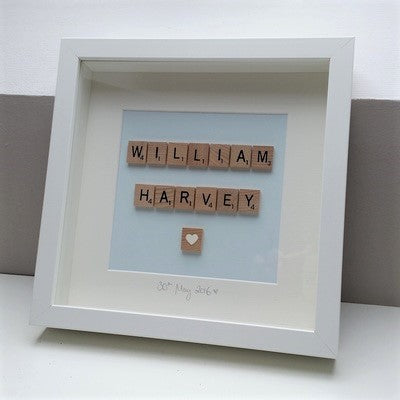 Personalised baby blue Scrabble name frame, pastel blue background in a handmade wooden 25x25cm deep box frame