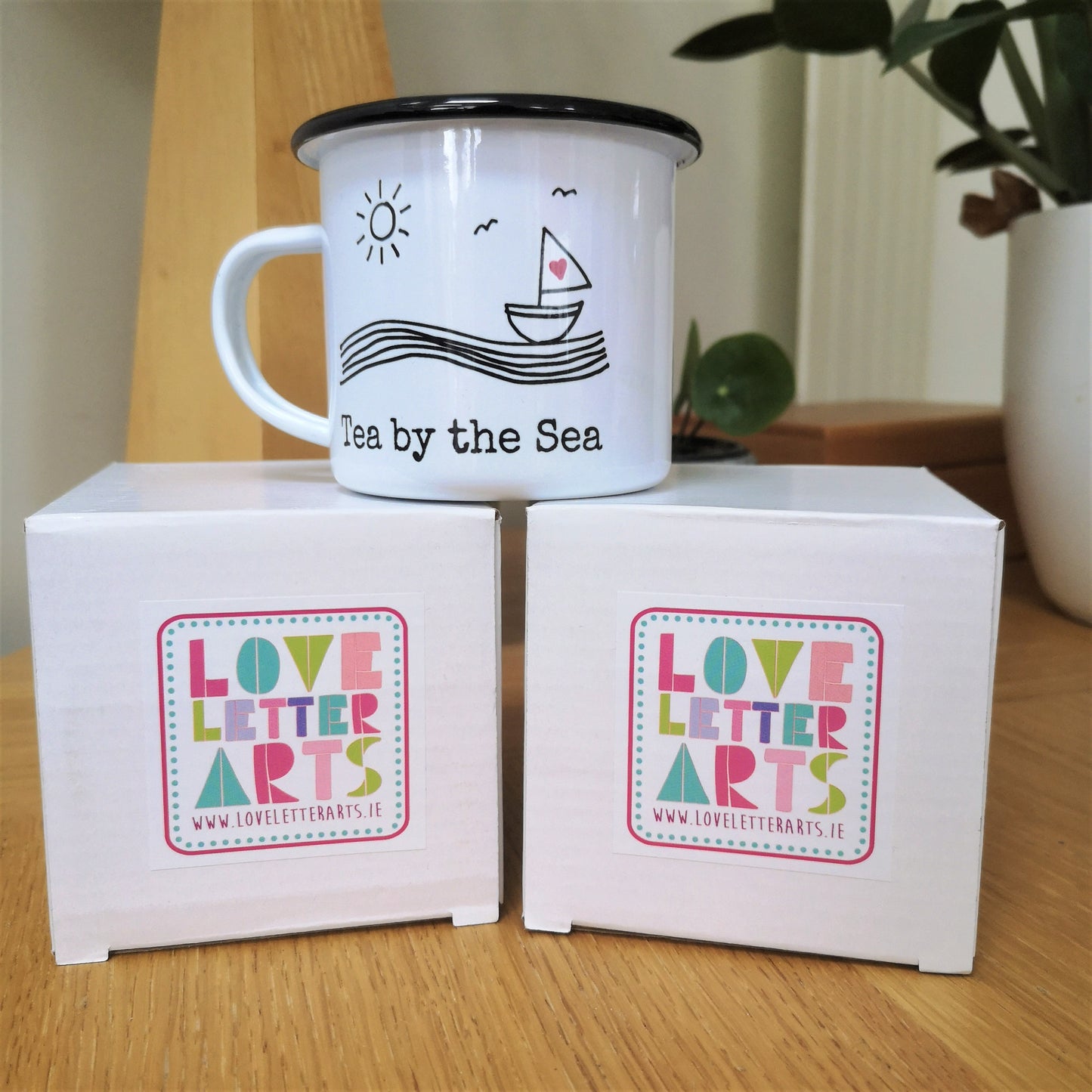 A photo of the cardboard boxes all my mugs come in, with a brightly coloured Love Letter Arts sticker on the top. Perfect for gifting
