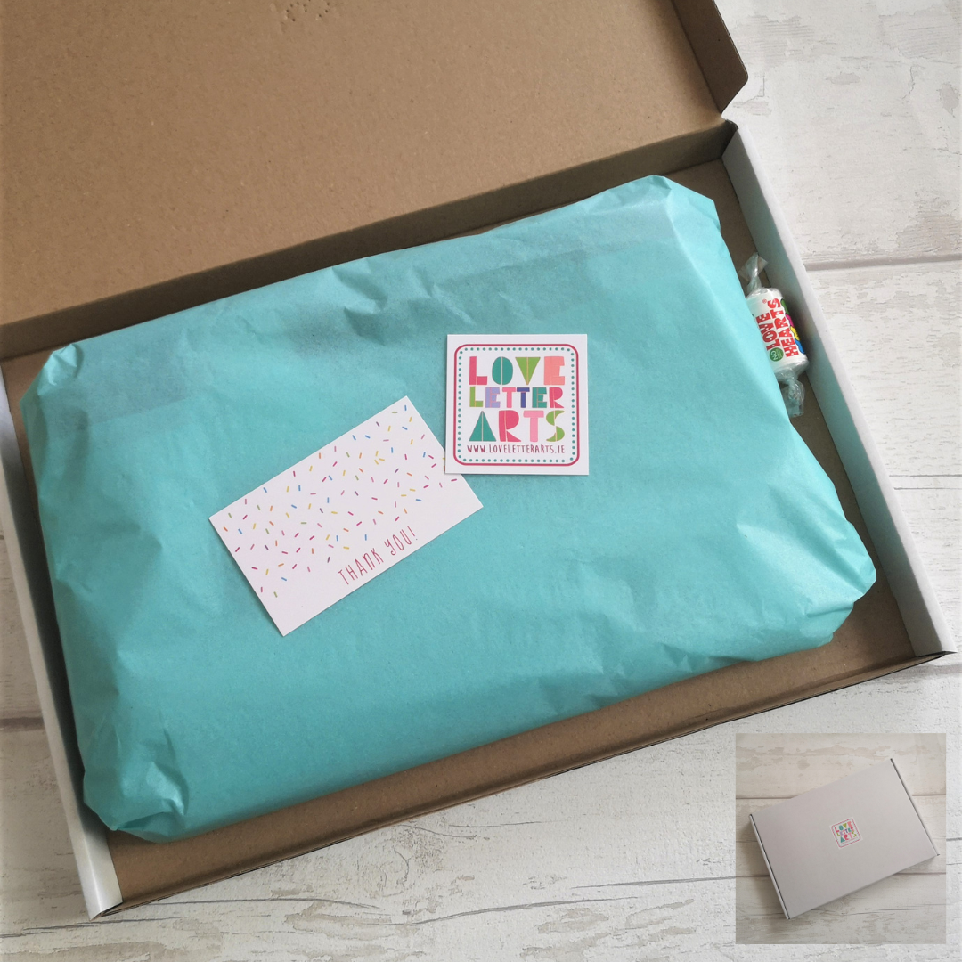 A photo showing the way I package all my totes - in coloured tissue paper with a thank you note, loveheart sweets, all contained in a white or brown craft cardboard box with my logo on the front